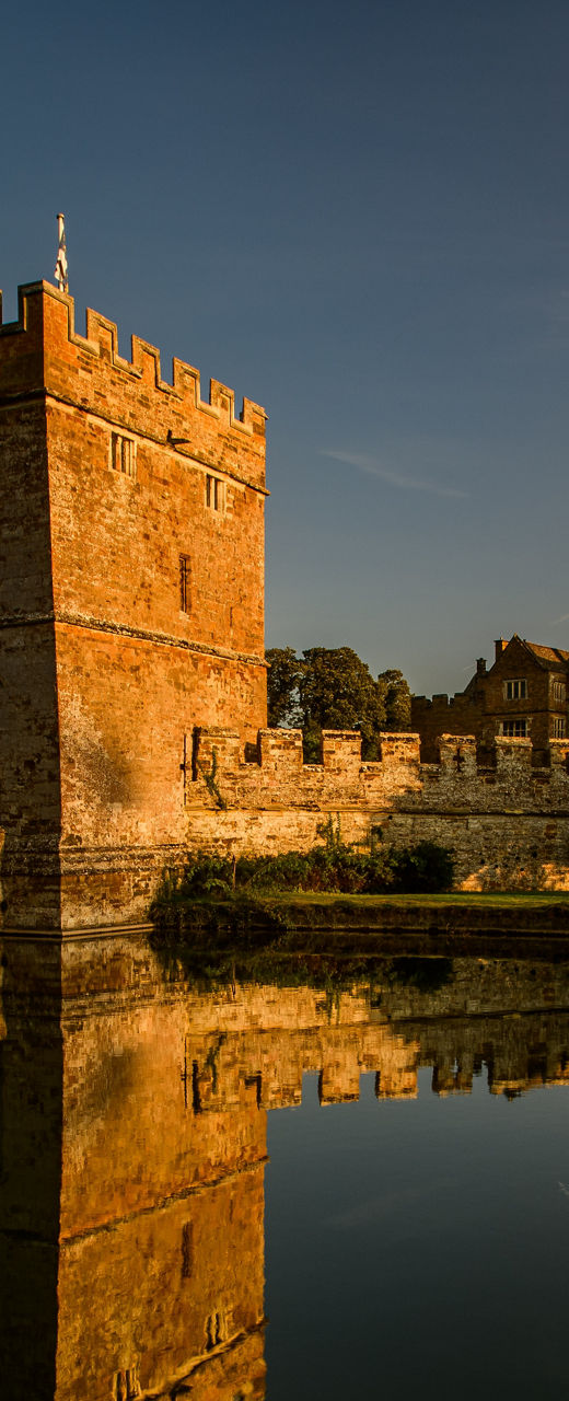 Historic castle with moat at sunset
