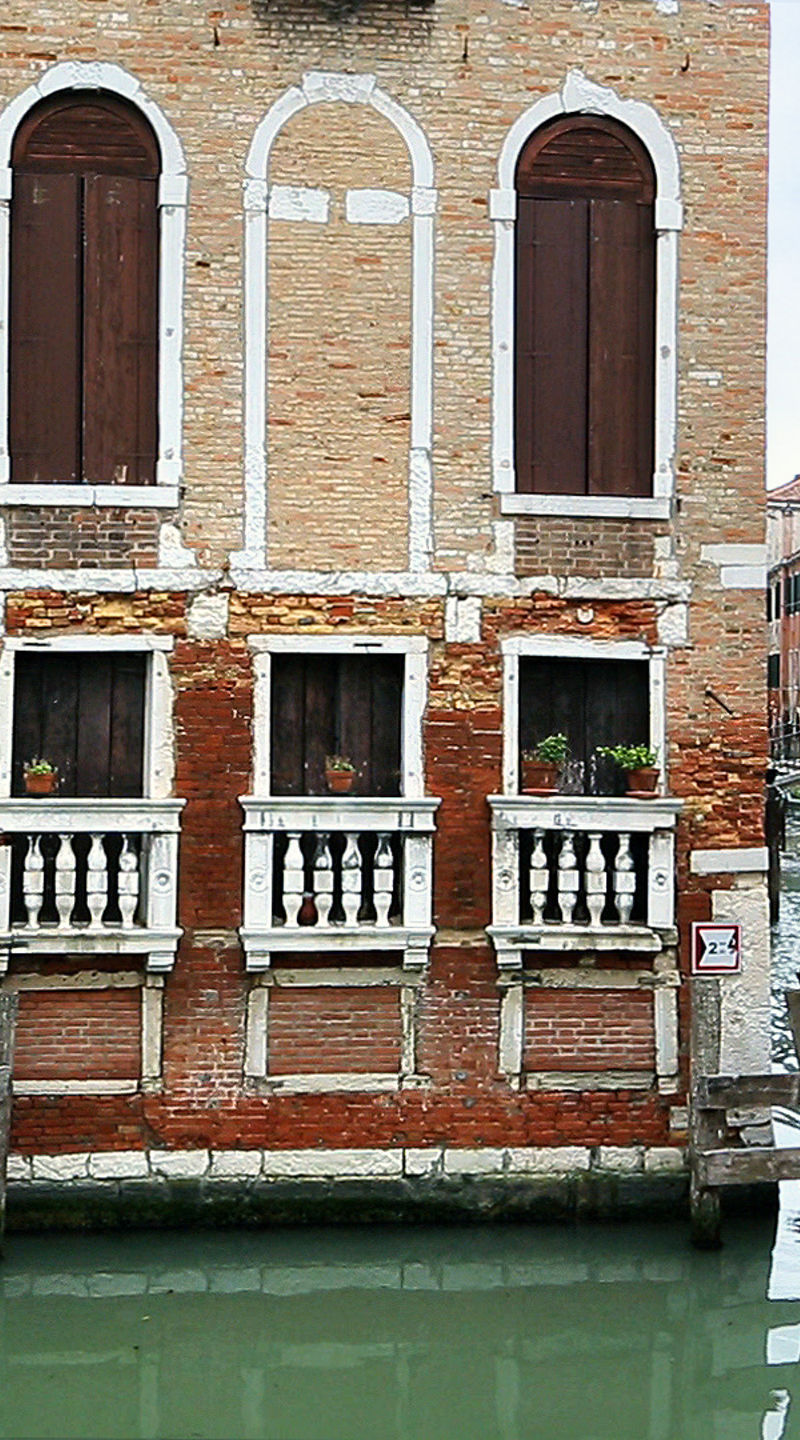 Historic Venetian canal with boat passing