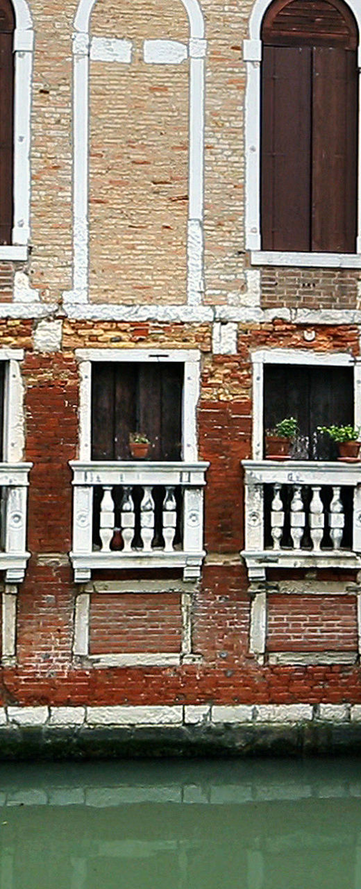 Historic Venetian canal with boat passing