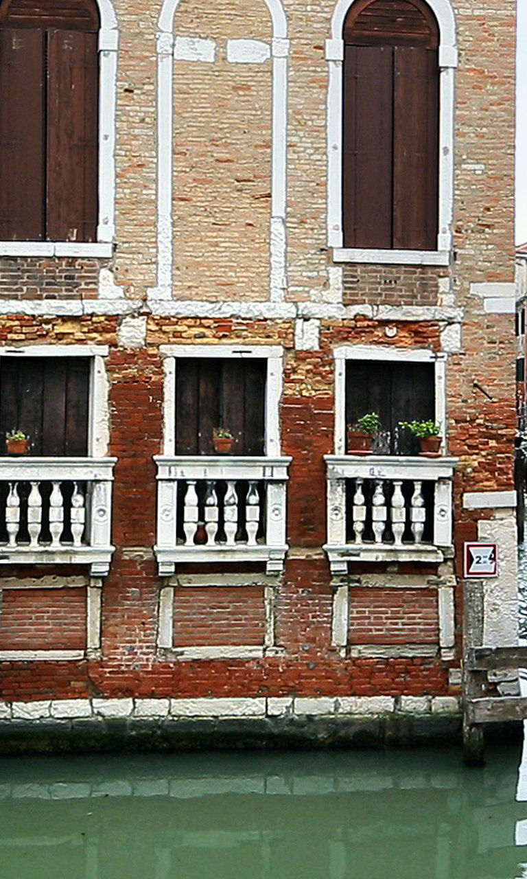 Historic Venetian canal with boat passing