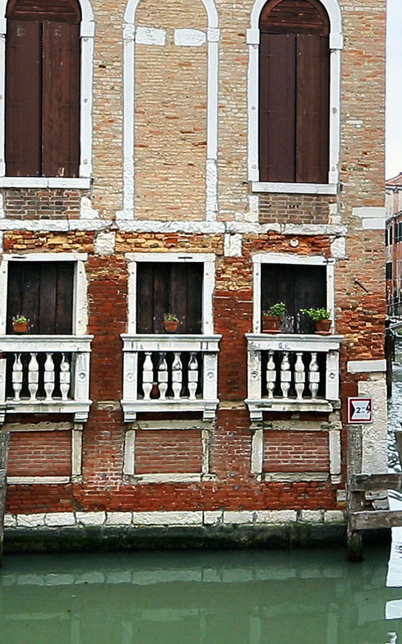 Historic Venetian canal with boat passing