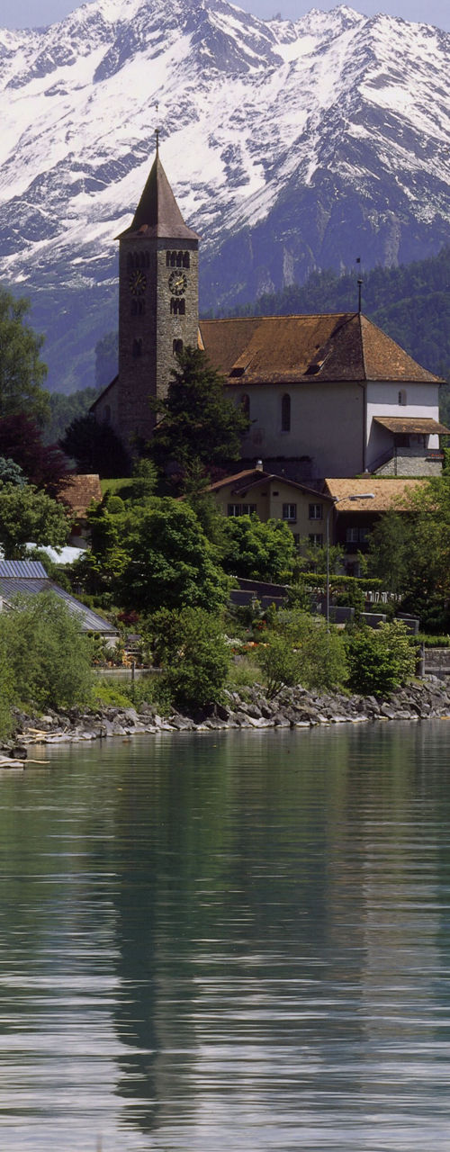 Scenic lakeside village with snowy mountains