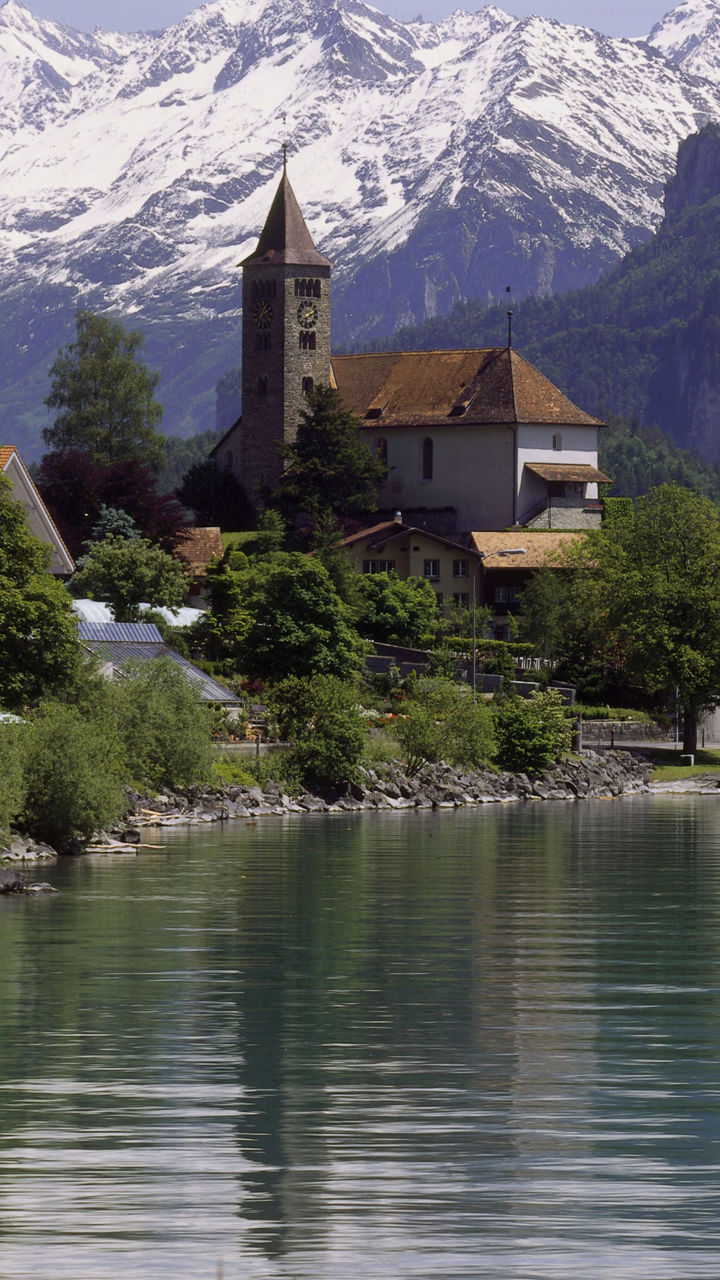 Scenic lakeside village with snowy mountains