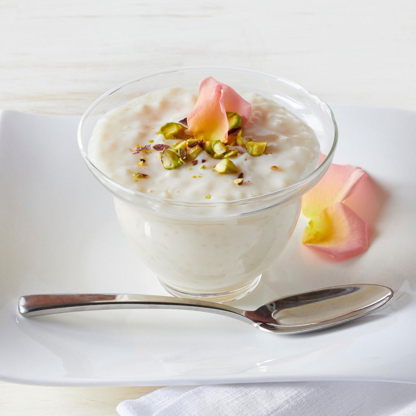 Glass bowl of dessert with pistachios
