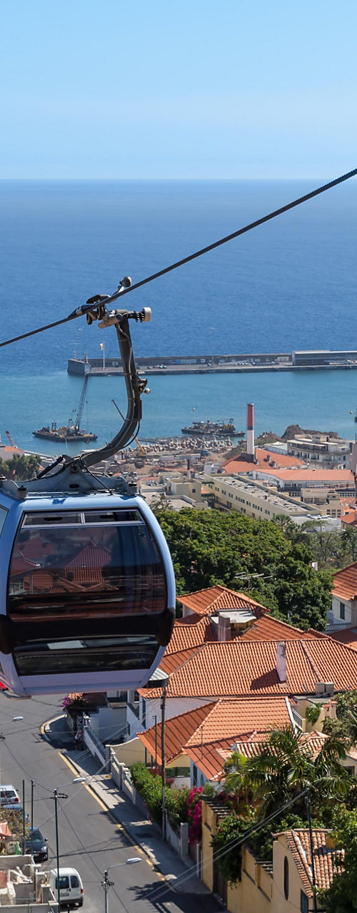 Cable car overlooking coastal city and ocean