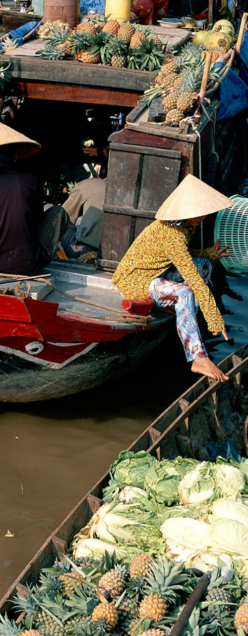 Bustling floating market with produce vendors