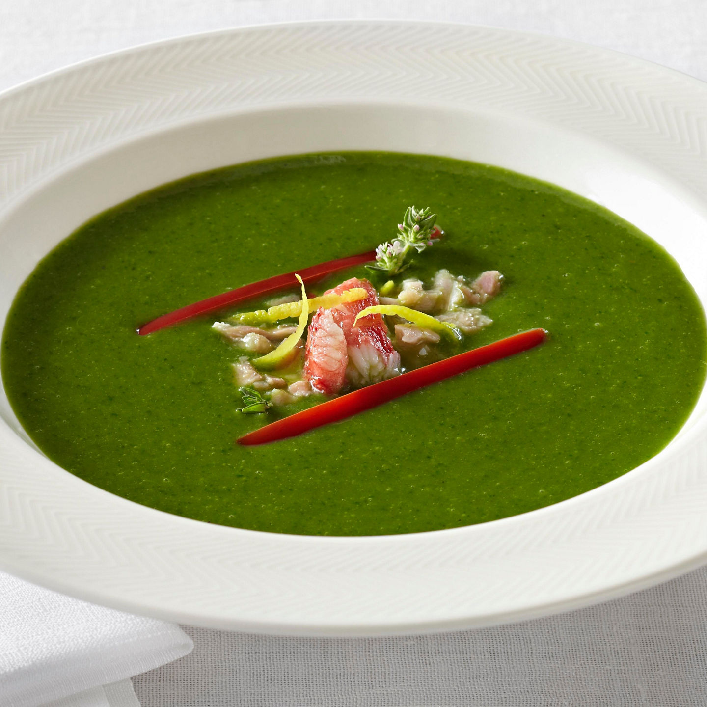 Vibrant green soup with garnish