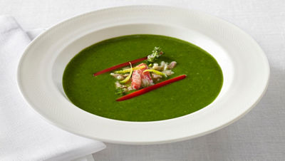 Vibrant green soup with garnish