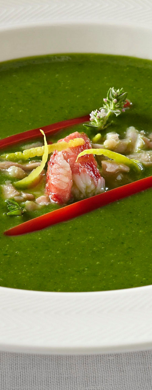 Vibrant green soup with garnish