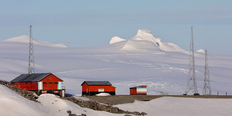 Remote Arctic research station with snowy peaks