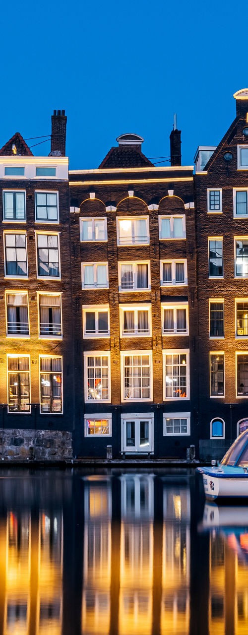 Scenic Amsterdam canal with illuminated houses