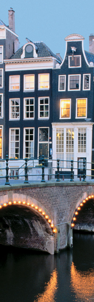 Scenic Amsterdam canal with illuminated bridges
