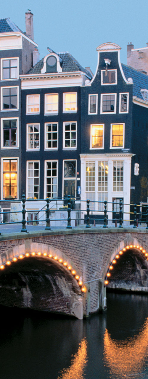 Scenic Amsterdam canal with illuminated bridges