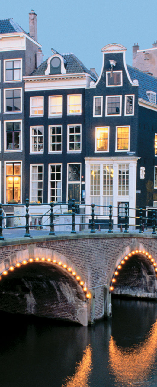 Scenic Amsterdam canal with illuminated bridges