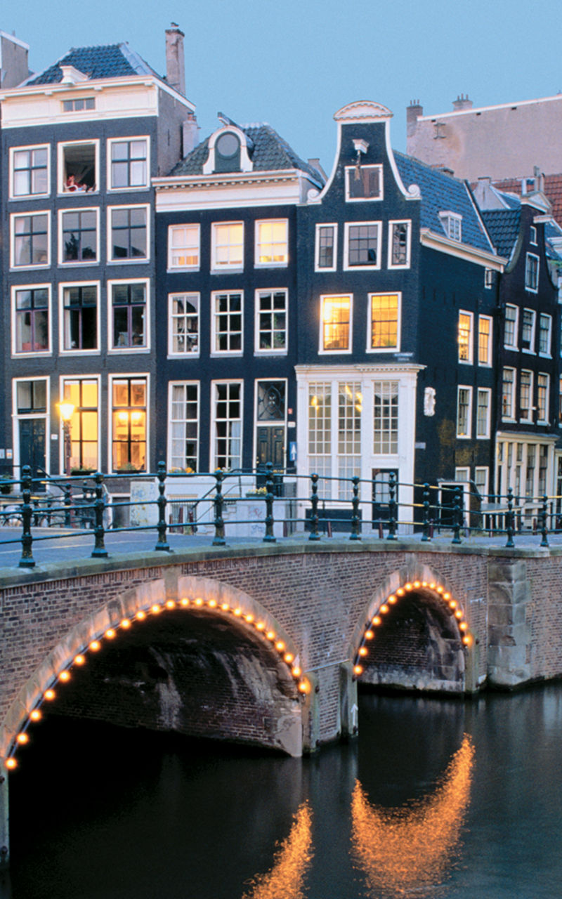 Scenic Amsterdam canal with illuminated bridges