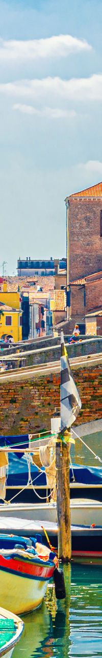 Scenic canal with boats in Italian town