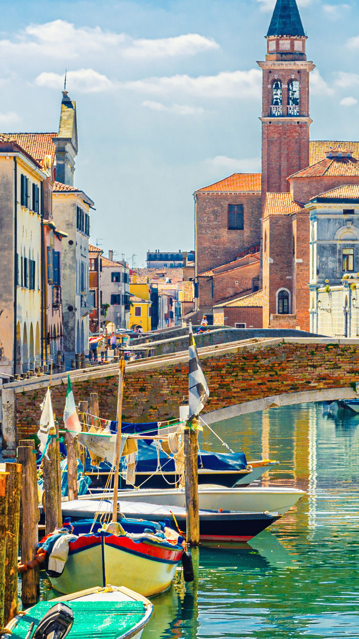 Scenic canal with boats in Italian town