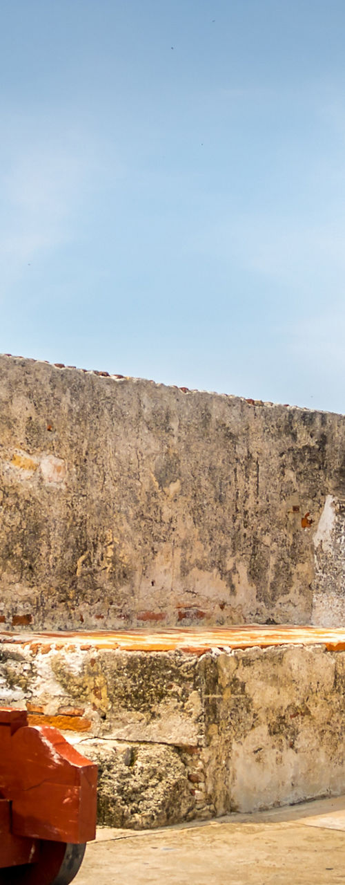 Historic fortress cannons overlooking coastal city