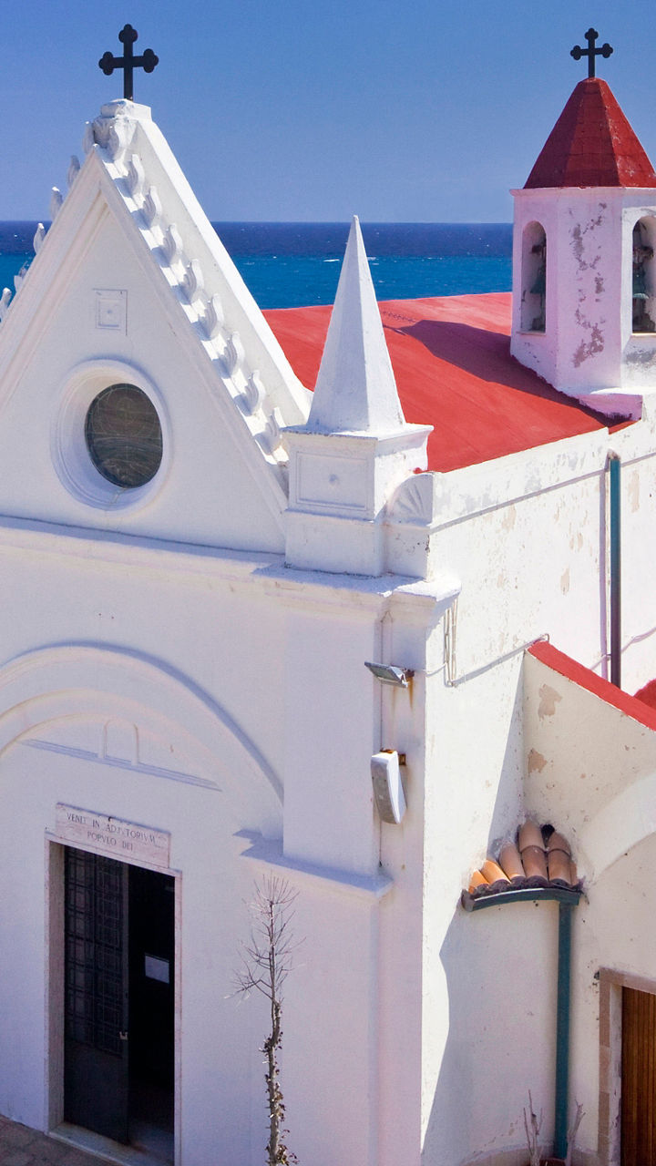 White coastal church with red roof