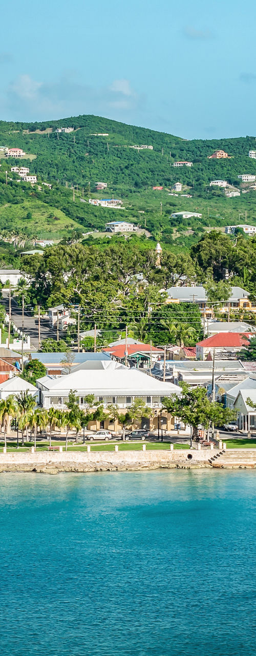 Coastal town with lush green hills