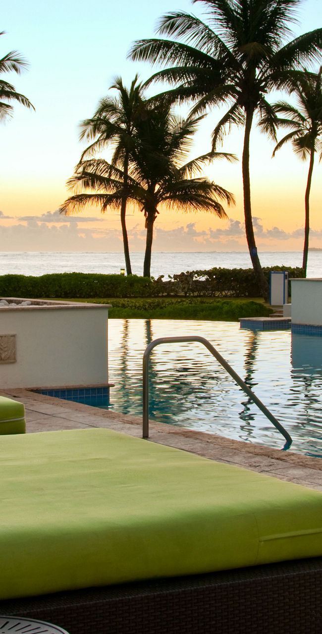 Tropical resort pool at sunrise