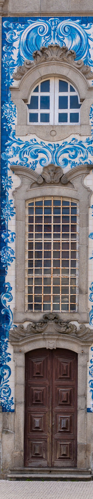Cyclist passing ornate blue tile facade