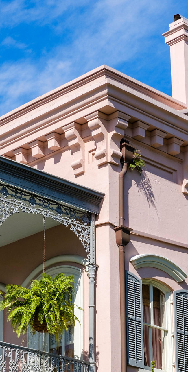 Elegant pink Victorian house with ornate balconies