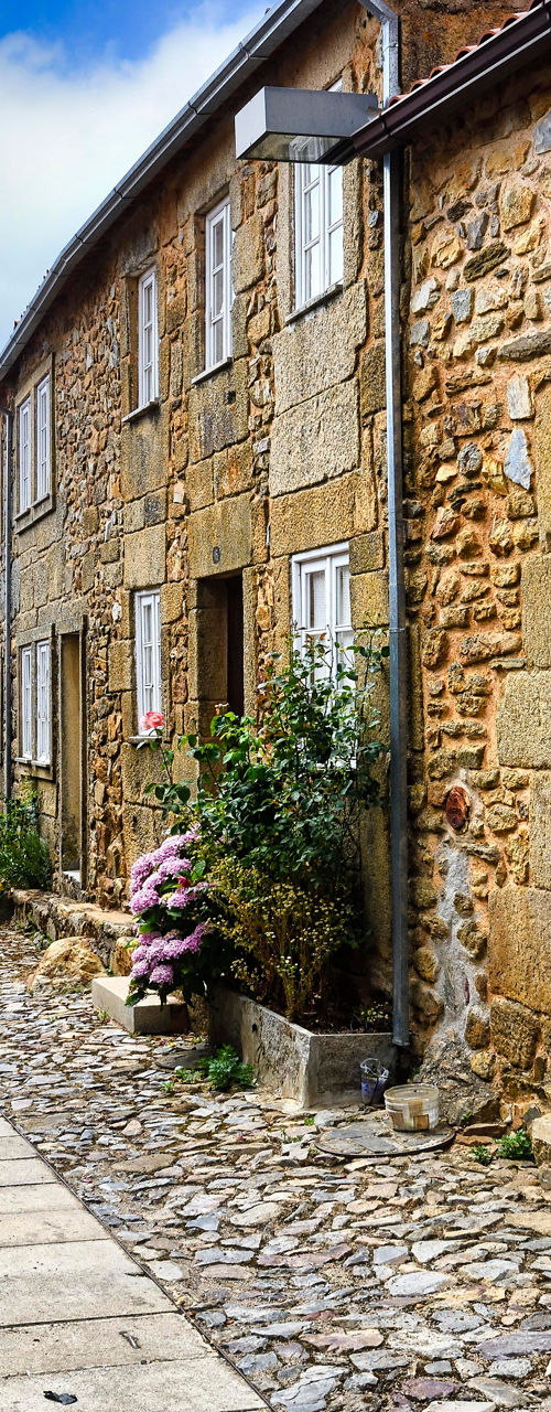 Rustic stone village street with flowers