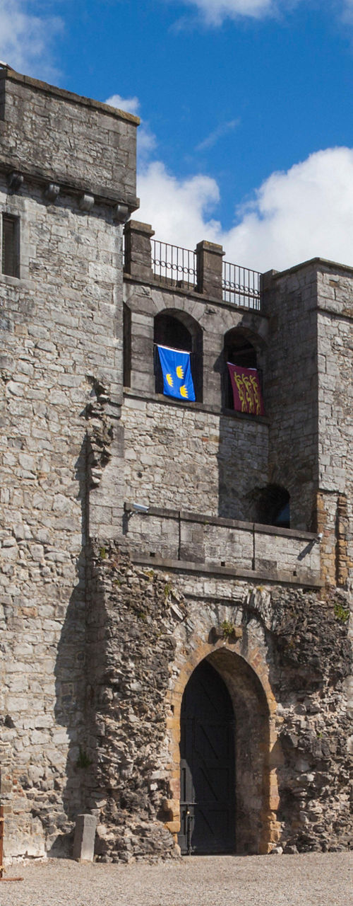 Historic stone castle with flags and courtyard