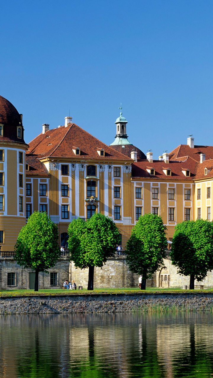 Baroque castle reflected in serene lake