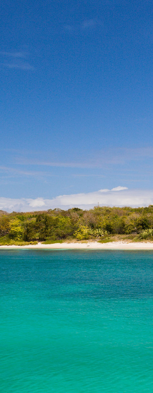 Sailboat anchored in turquoise bay