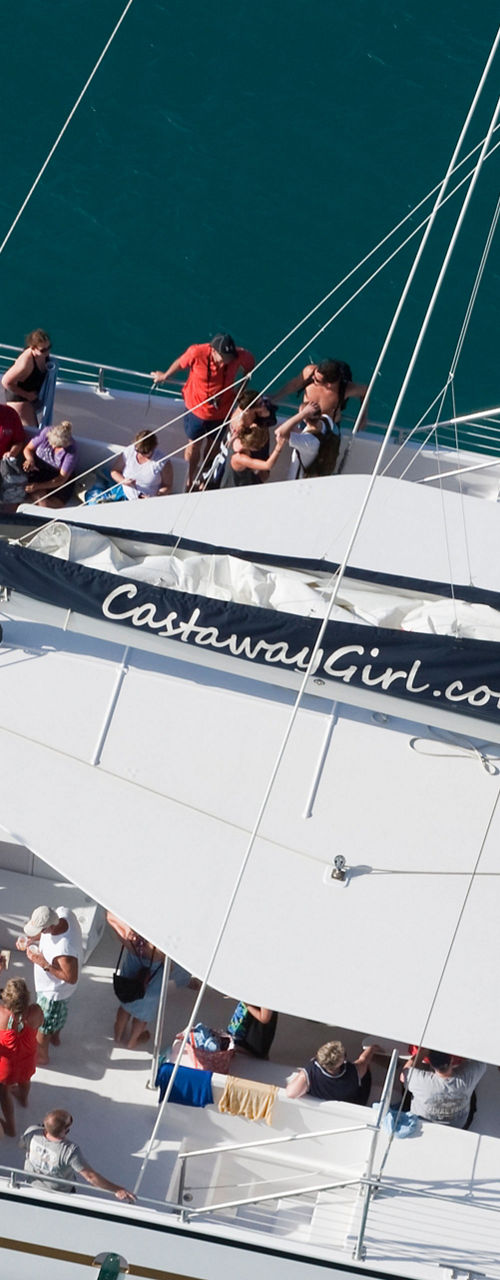 Catamaran with passengers on turquoise water