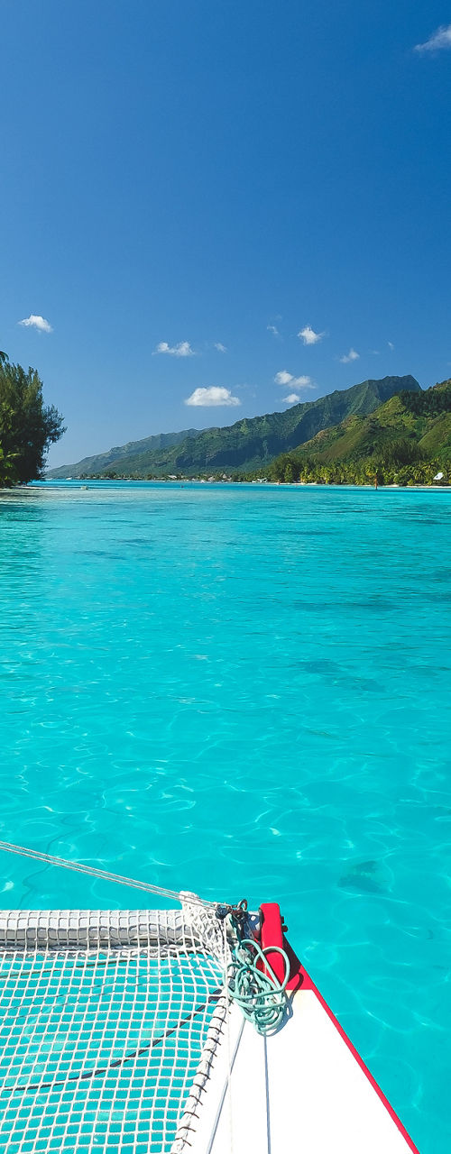 Catamaran sailing on tropical turquoise lagoon