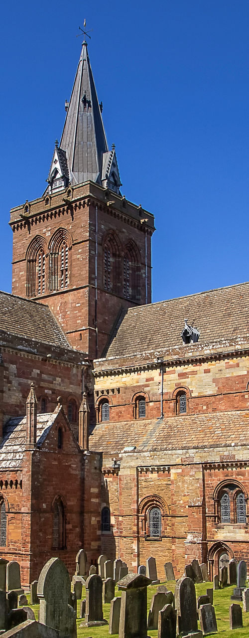 Historic cathedral with cemetery under blue sky