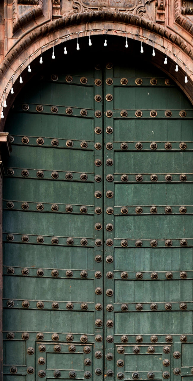 Historic green door with ornate architecture