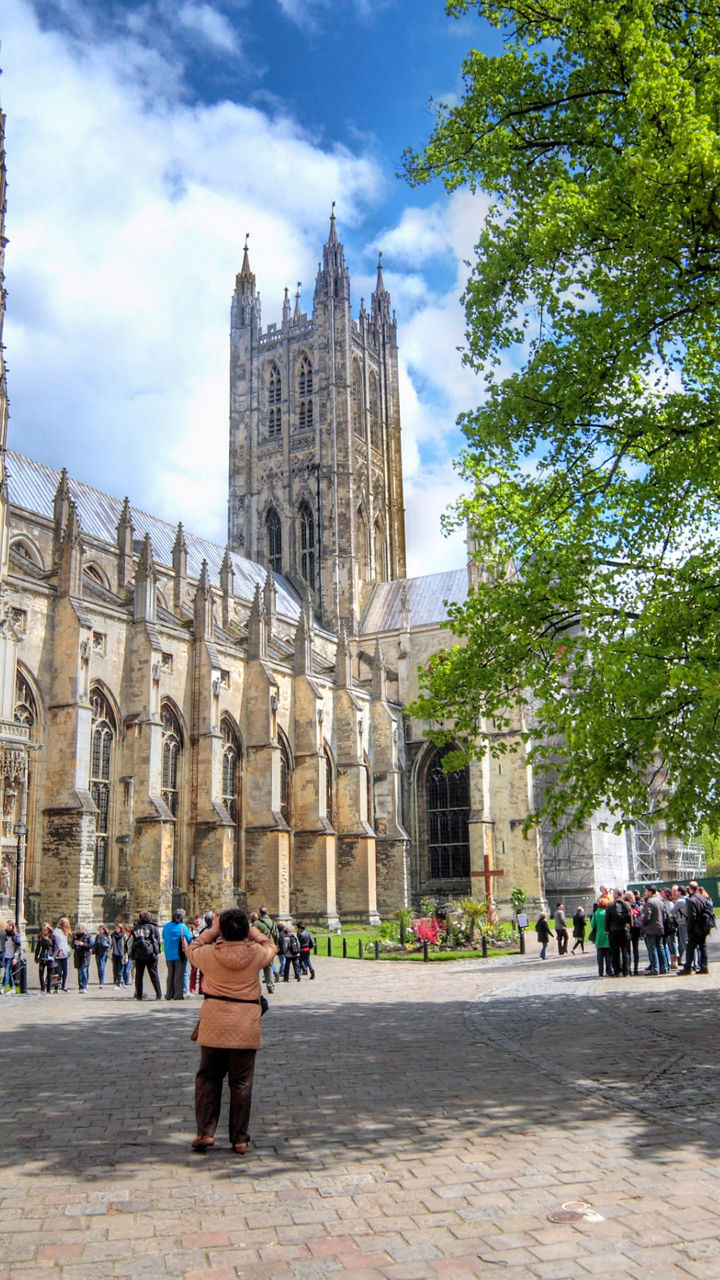 Canterbury Cathedral with tourists and tree