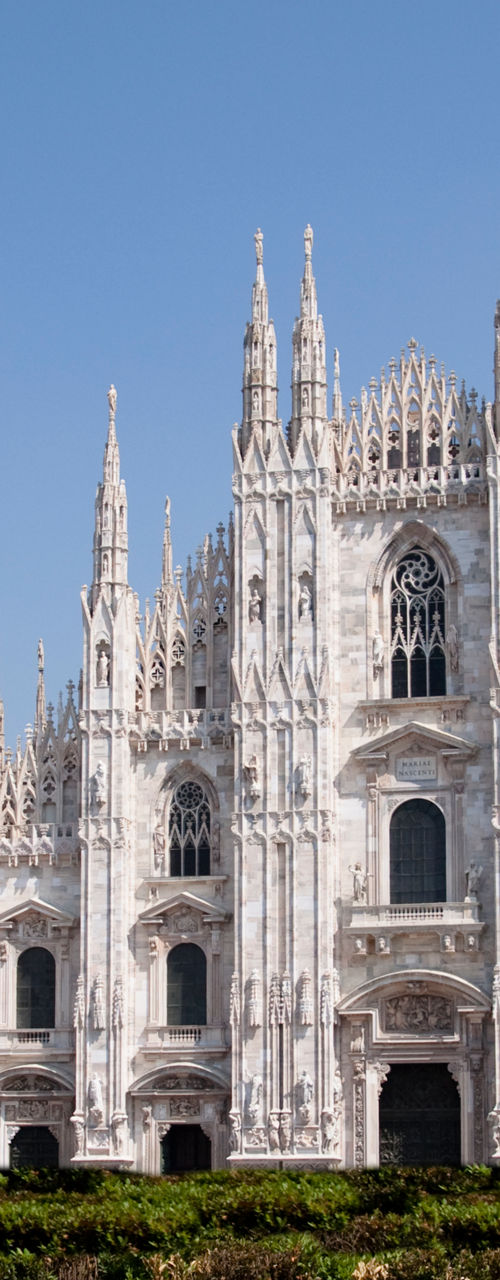 Historic Milan Cathedral with vibrant garden