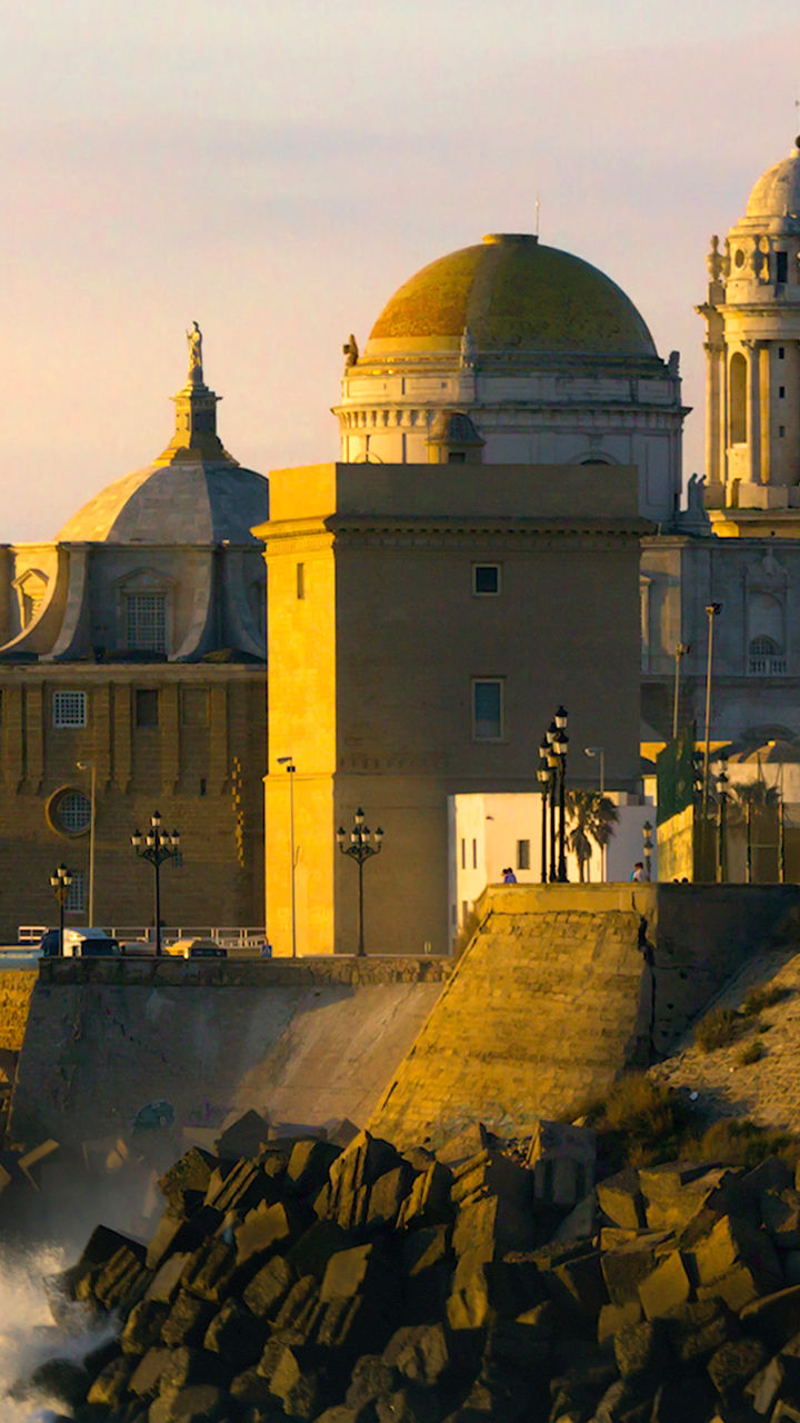 Coastal cityscape with historic cathedral at sunset