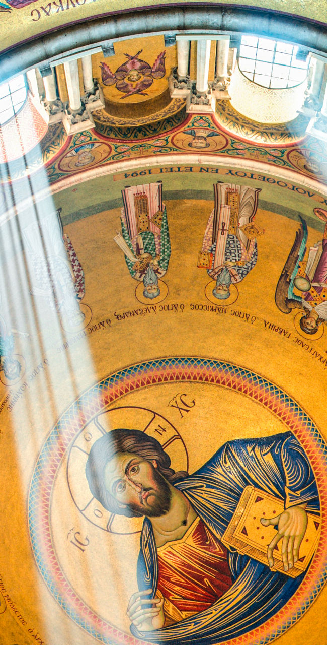 Golden dome with religious artwork and sunlight