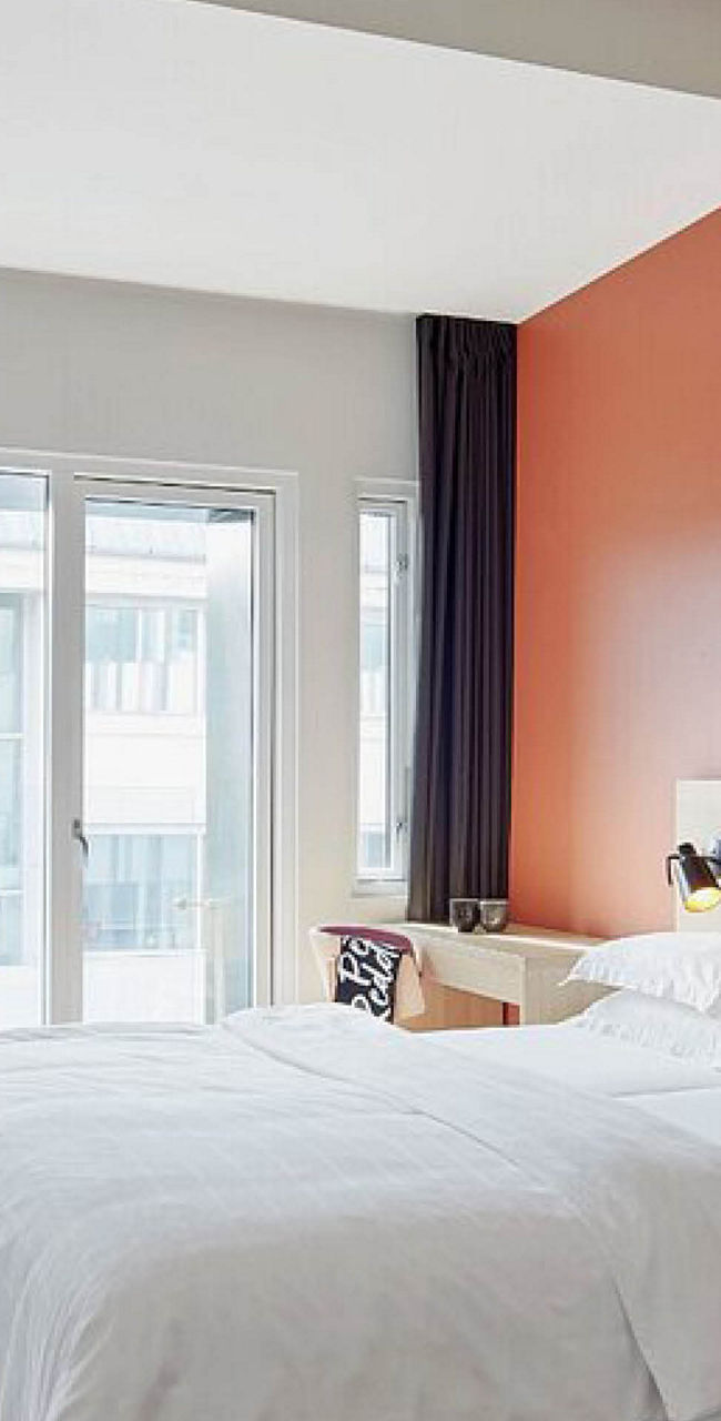 Modern hotel room with double bed and decor