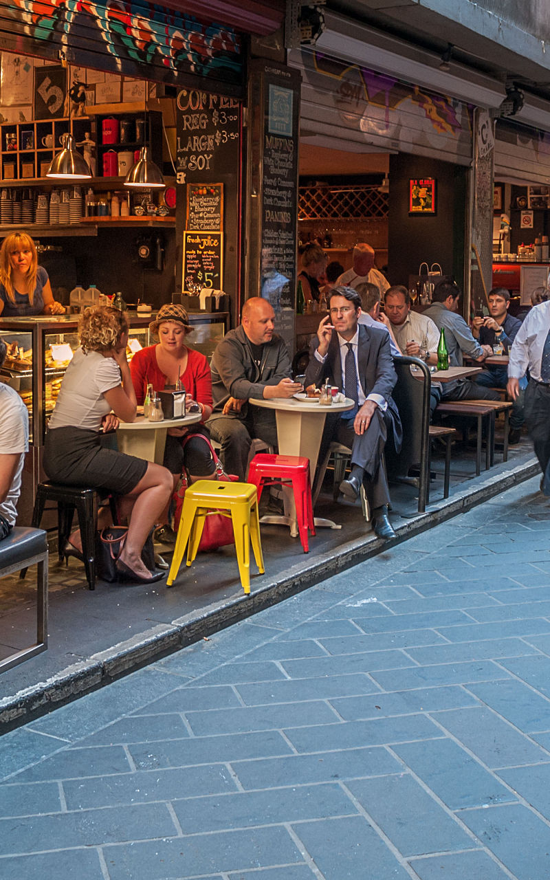 Bustling alleyway café scene with diners