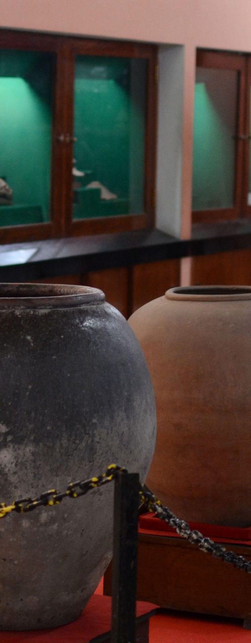 Ancient pottery display in museum setting