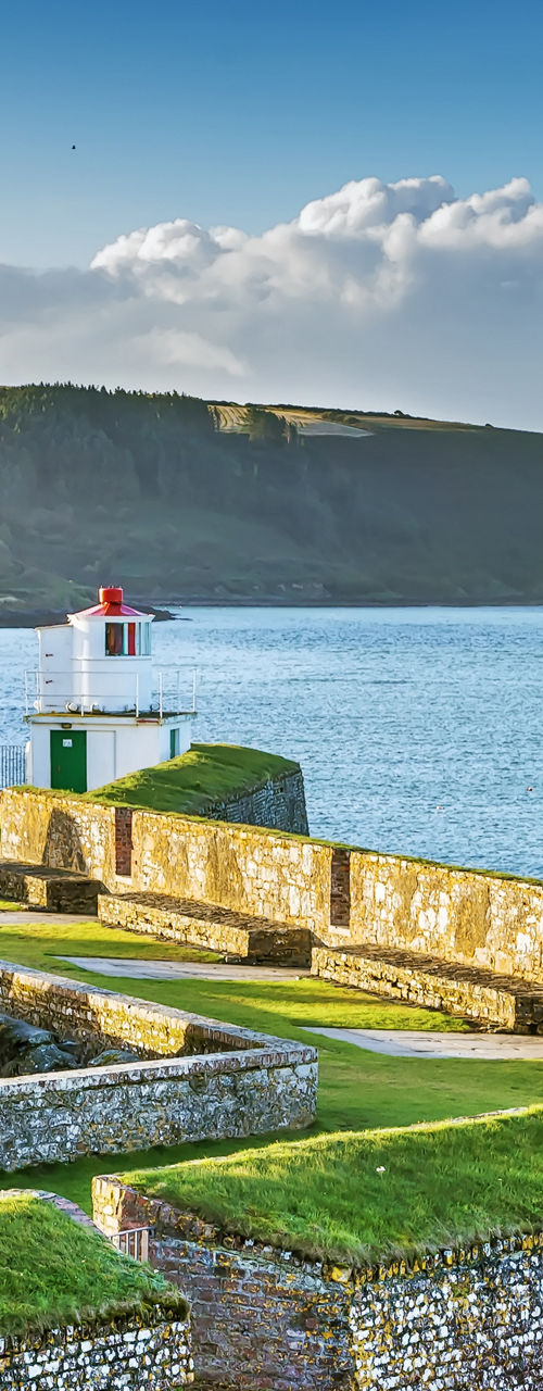 Historic coastal fortress with lighthouse view