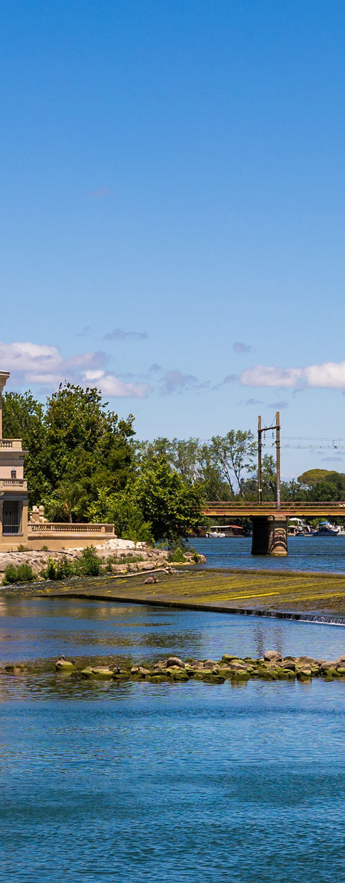 Riverside building with scenic bridge view