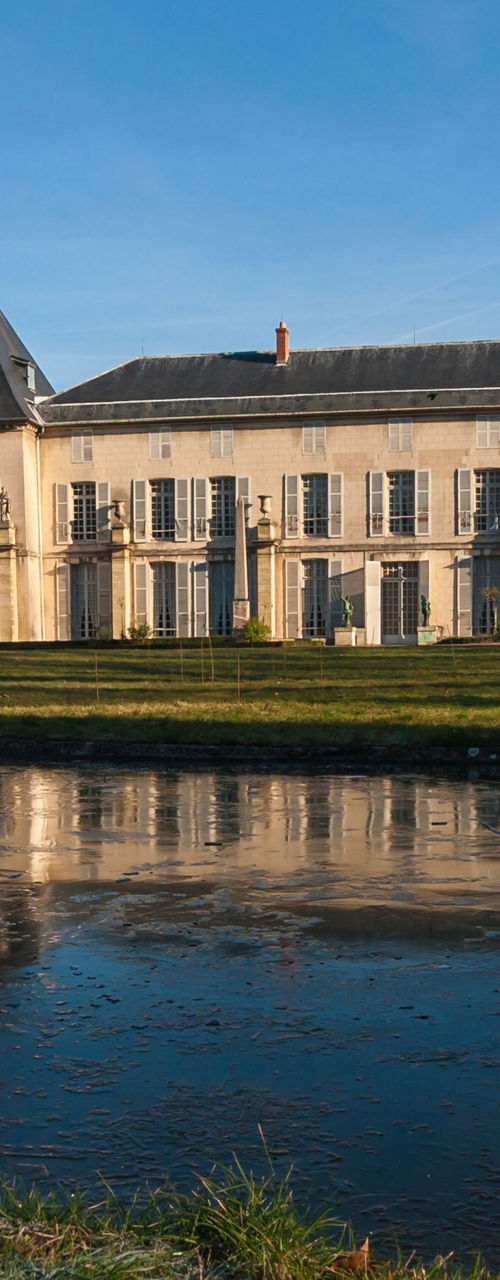 Historic mansion with frozen pond reflection