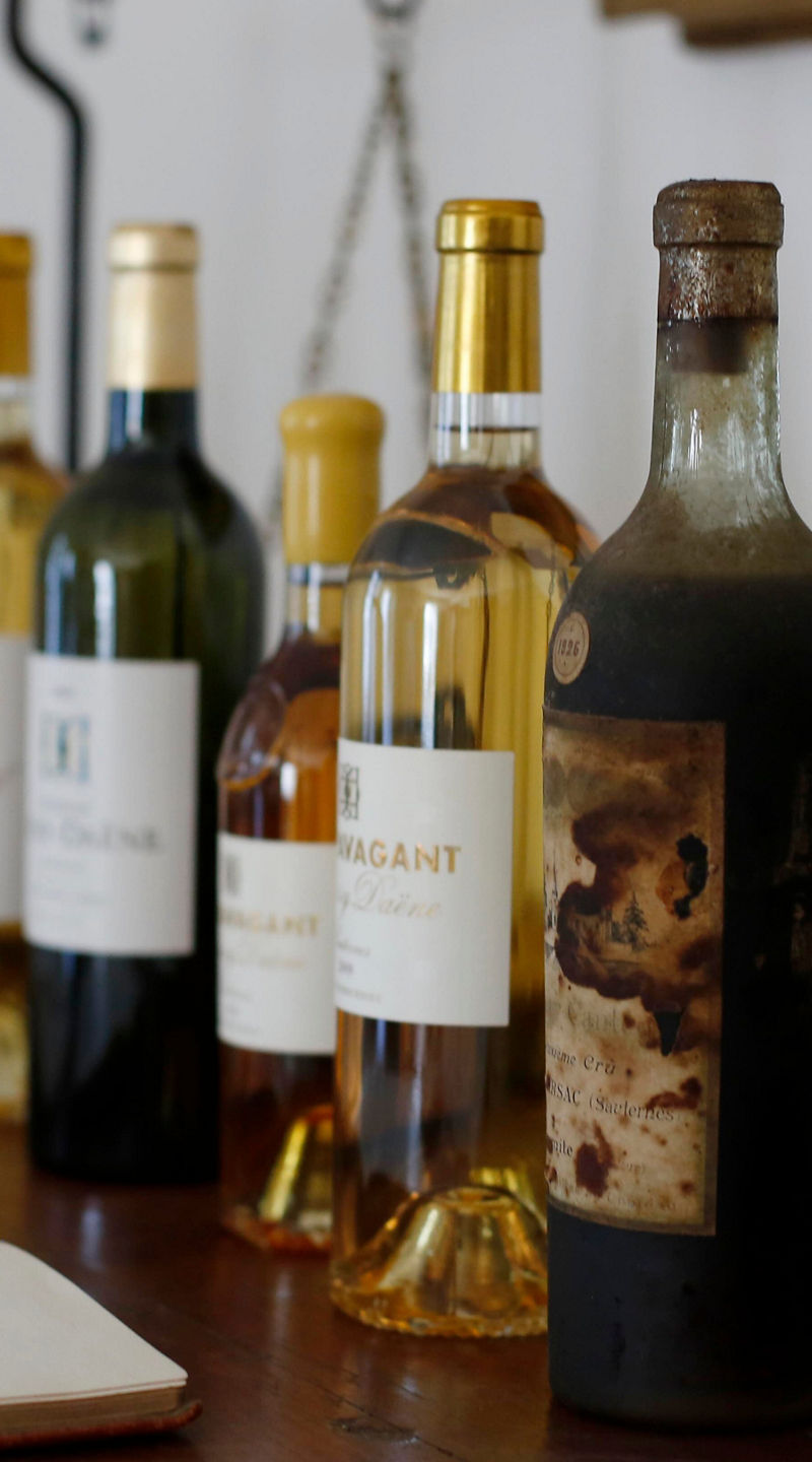 Assorted wine bottles on wooden table