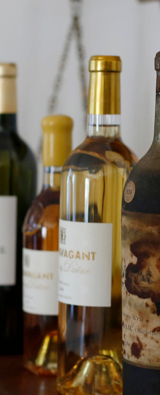 Assorted wine bottles on wooden table