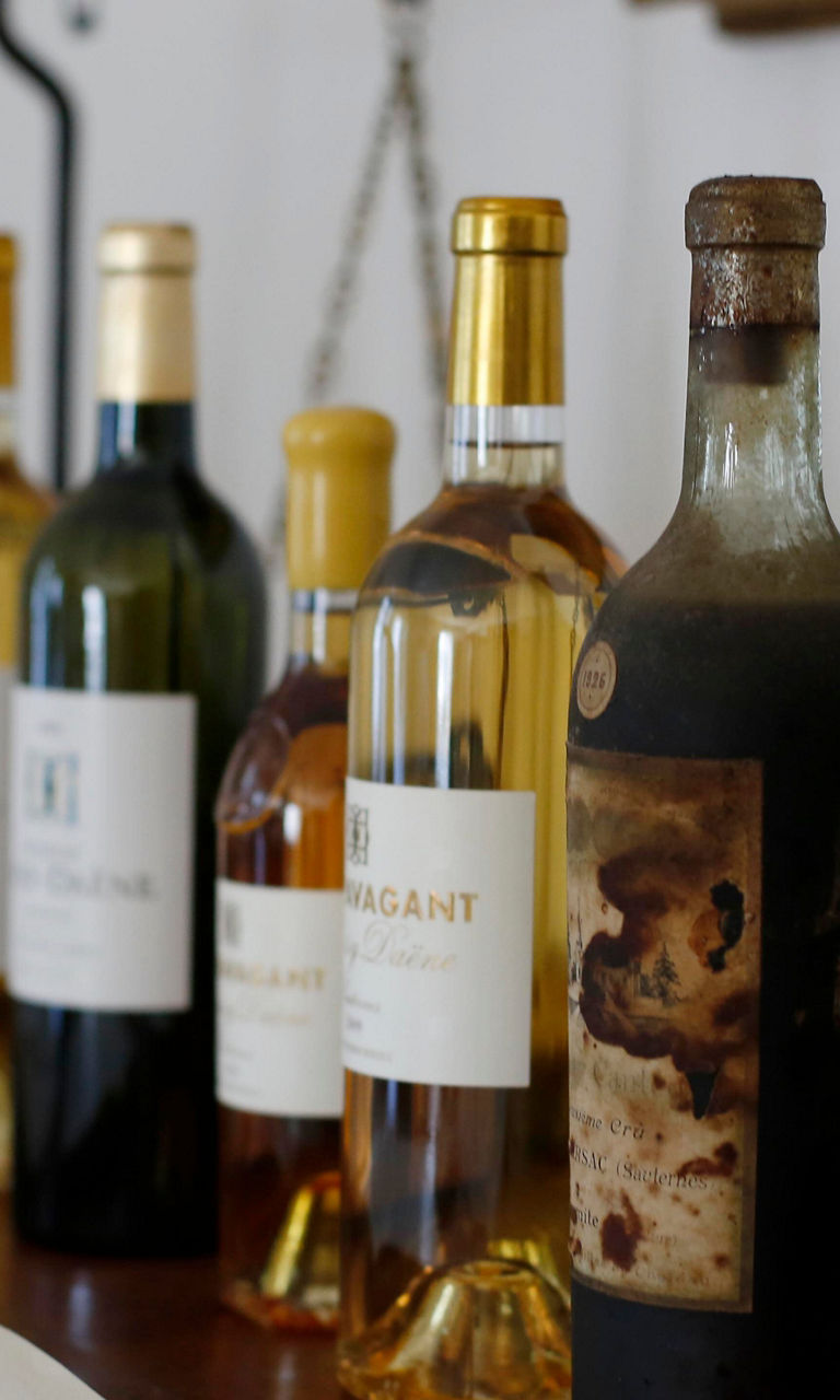 Assorted wine bottles on wooden table