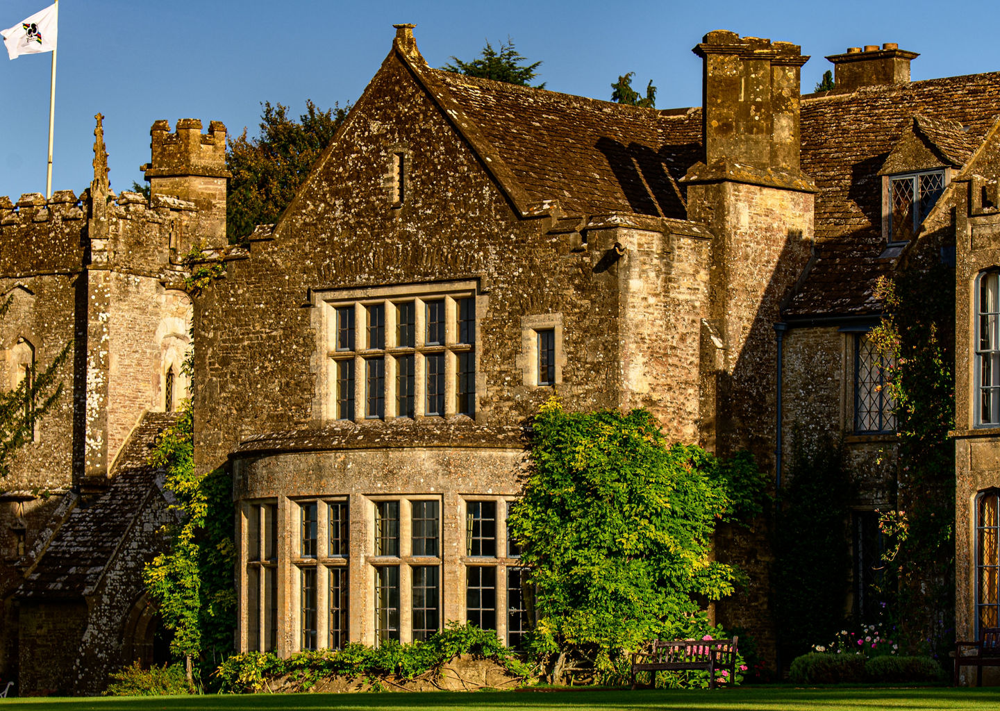 Historic stone manor with lush green lawn