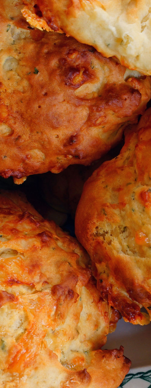 Freshly baked cheese biscuits on patterned plate